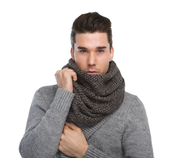 Attractive young man posing with gray wool scarf — Stock Photo, Image