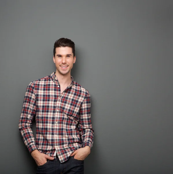 Encantador joven con camisa a cuadros sonriendo — Foto de Stock