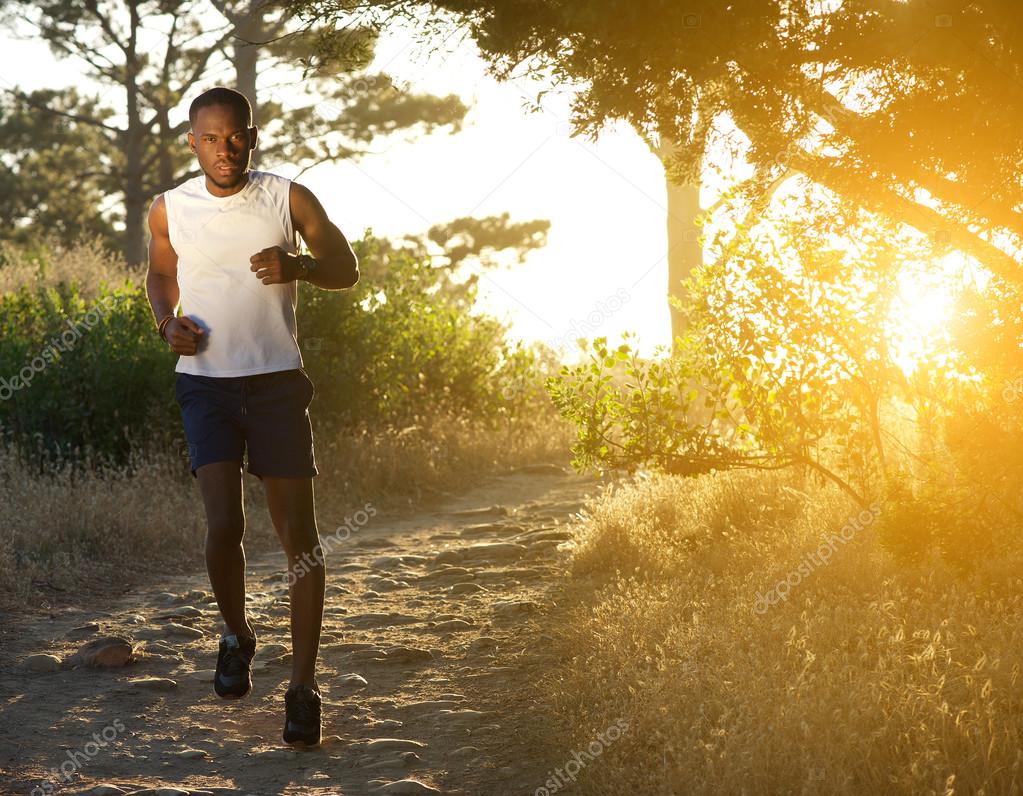 Healthy african american man jogging in nature