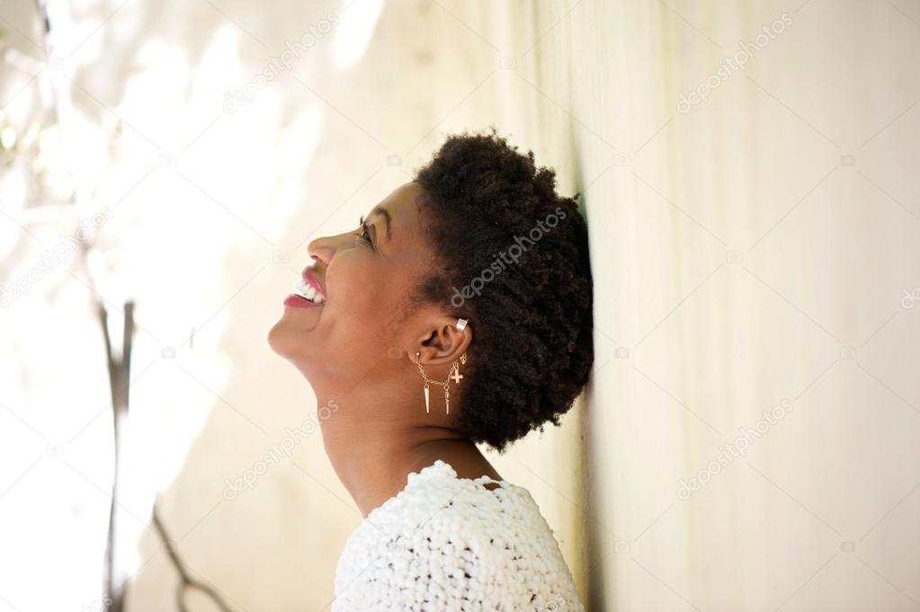 Young black woman smiling and looking up