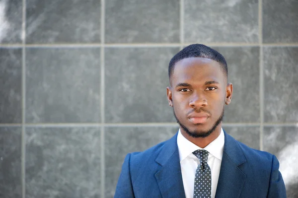 Handsome businessman on gray background — Stock Photo, Image