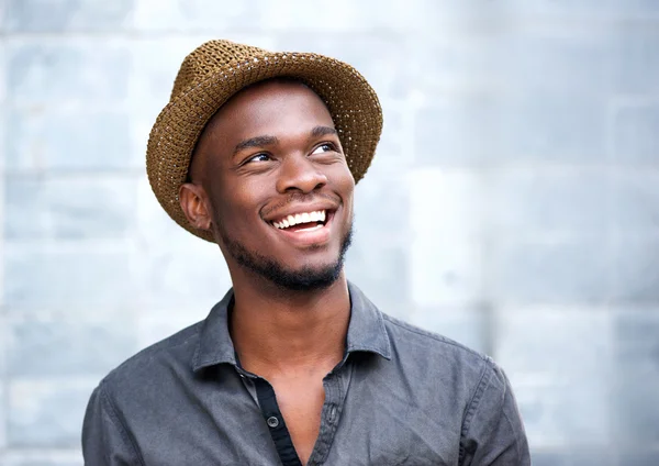 Close up portrait of a happy young african american man laughing