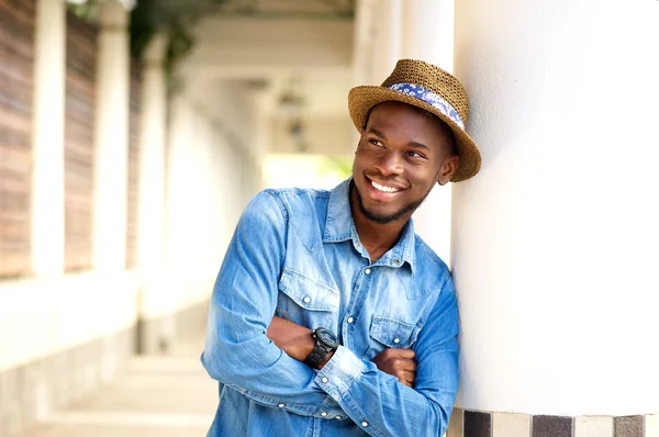 Stylischer junger Mann lächelt mit verschränkten Armen — Stockfoto