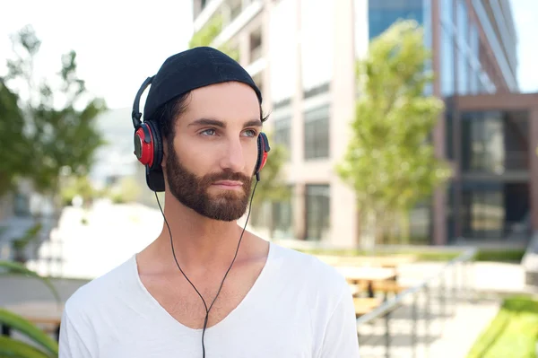 Handsome young man outdoors with headphones — Stock Photo, Image