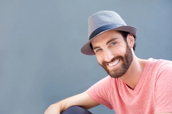 Close up portrait of a smiling young man with hat — Stock Photo, Image