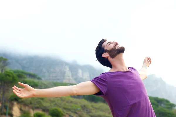 Carefree man smiling with arms open — Stock Photo, Image