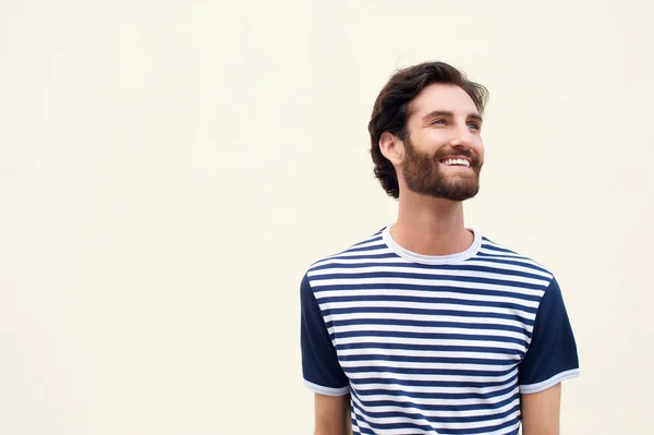 Cheerful young man with beard smiling on white background — Stock Photo, Image