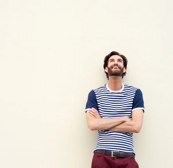 Happy man laughing with arms crossed and looking up — Stock Photo, Image