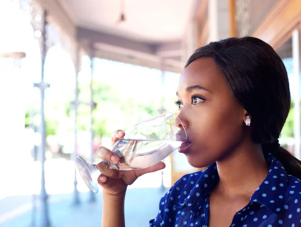 Young business woman drinking water