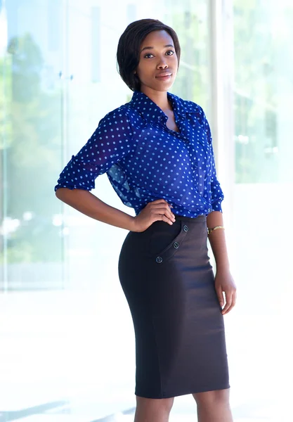 Young business woman standing alone outside