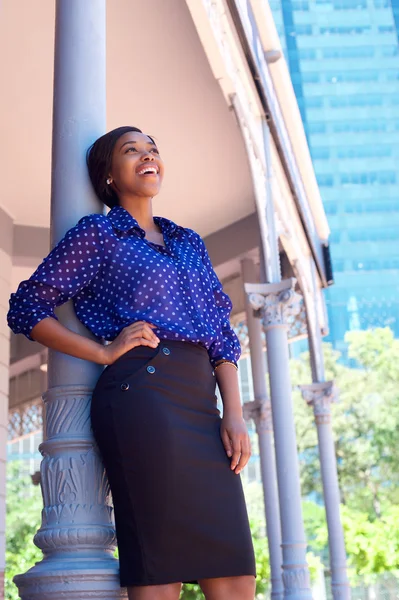 Happy business woman laughing outside office building Stock Image