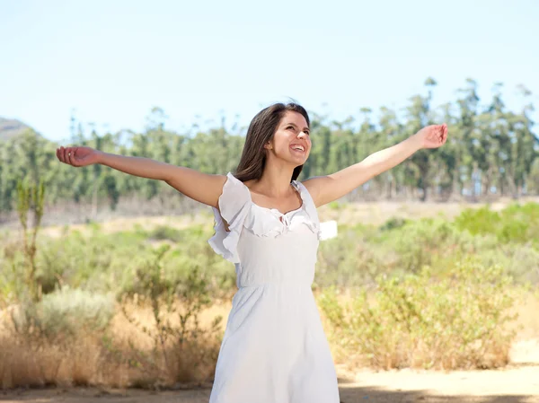 Happy young woman smiling with arms spread open — Stock Photo, Image