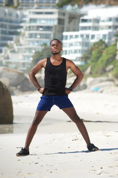 Man standing outdoors doing breathing exercises