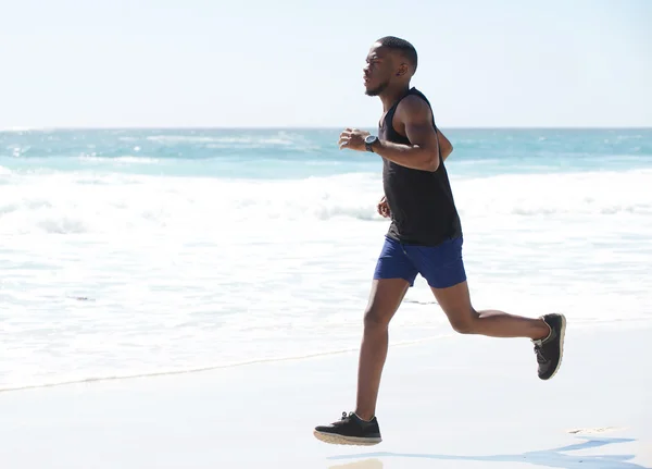 Young man running exercise on the beach — Stock Photo, Image