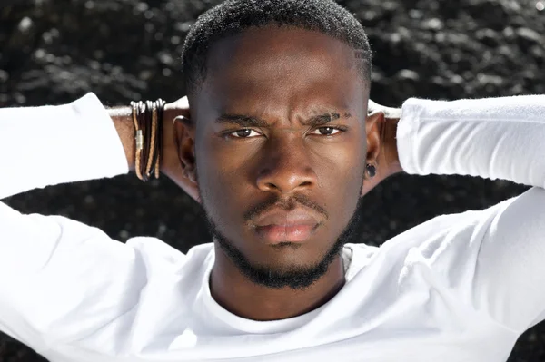 Male fashion model posing with hands behind head — Stock Photo, Image