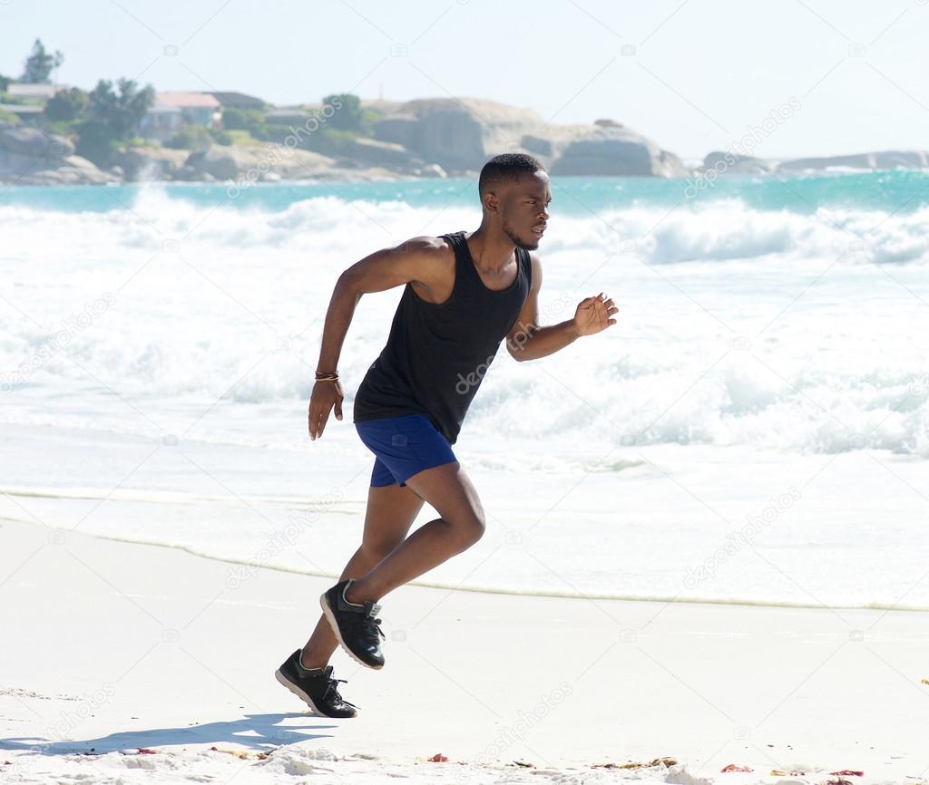 Fitness man running on the beach