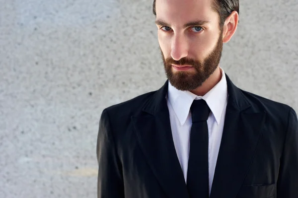 Male fashion model in black suit and tie — Stock Photo, Image