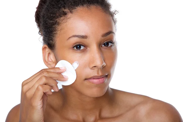 Young woman cleaning face with make up removal sponge — Stock Photo, Image