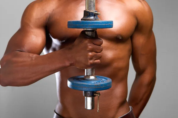 Strong african american man holding weights — Stock Photo, Image