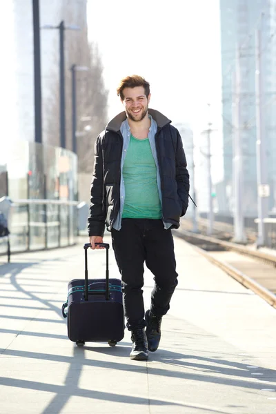 Hombre feliz caminando en la plataforma de la estación de tren con bolsa —  Fotos de Stock