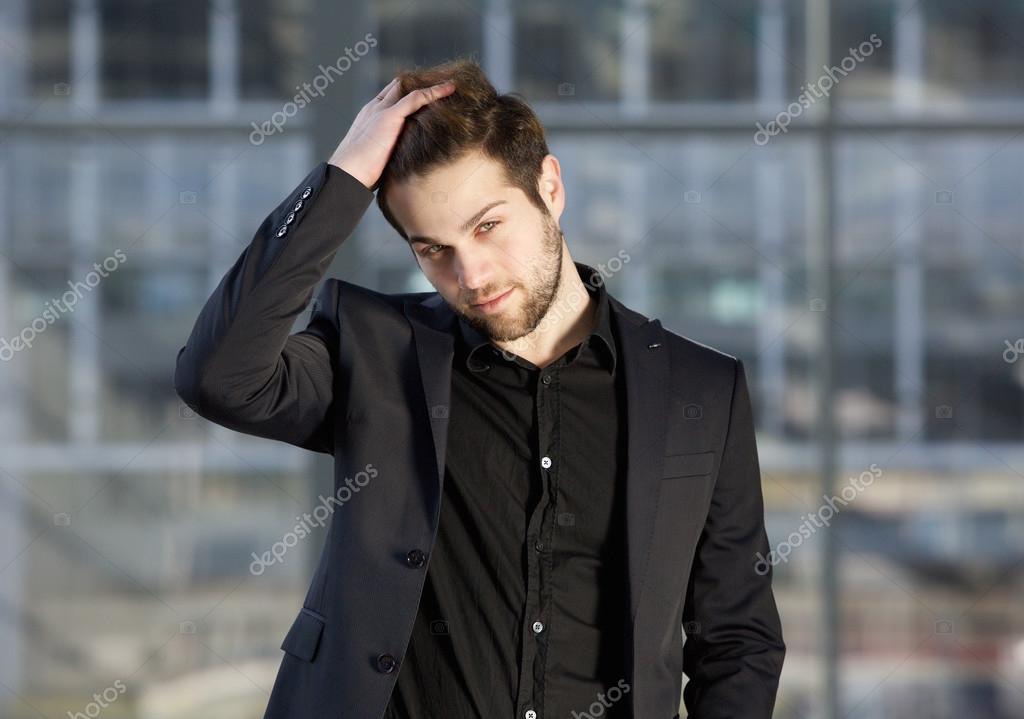 Handsome Male Fashion Model Posing With Hand In Hair Stock Photo