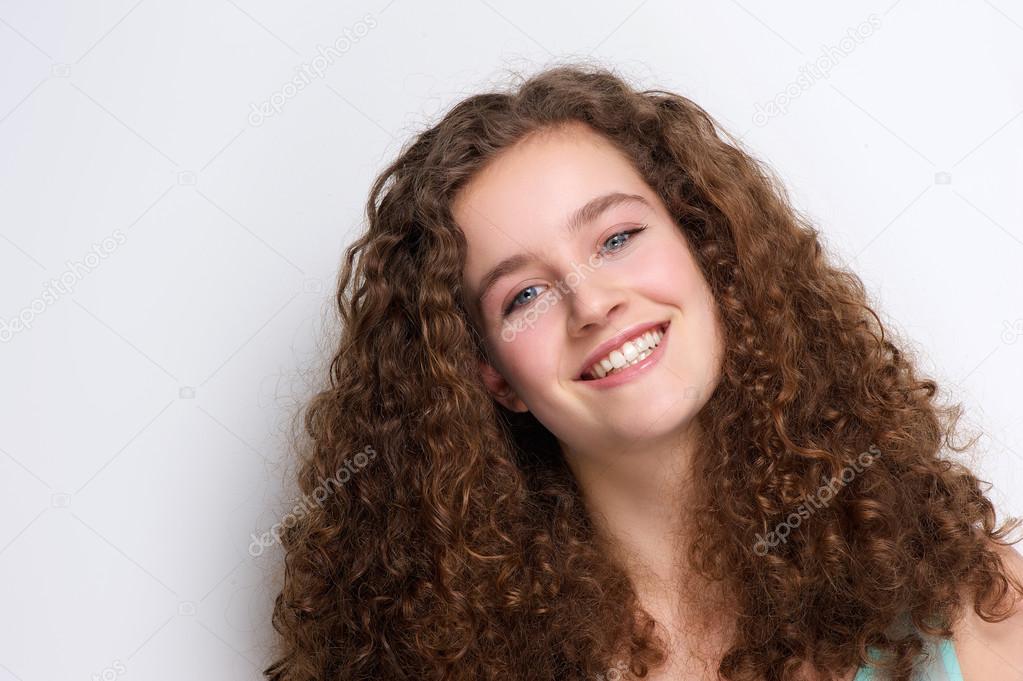 Happy Teenage Girl Smiling With Curly Hair Stock Photo