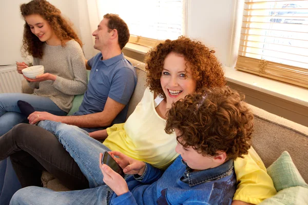 Happy family sitting on sofa enjoying tim together — Stock Photo, Image