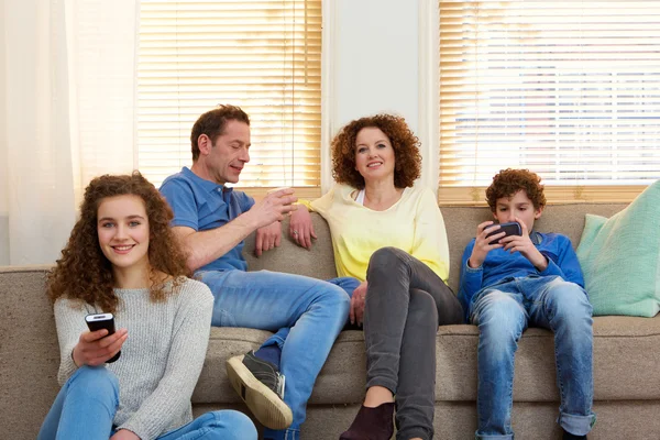 Portræt af en glad familie afslappende derhjemme - Stock-foto