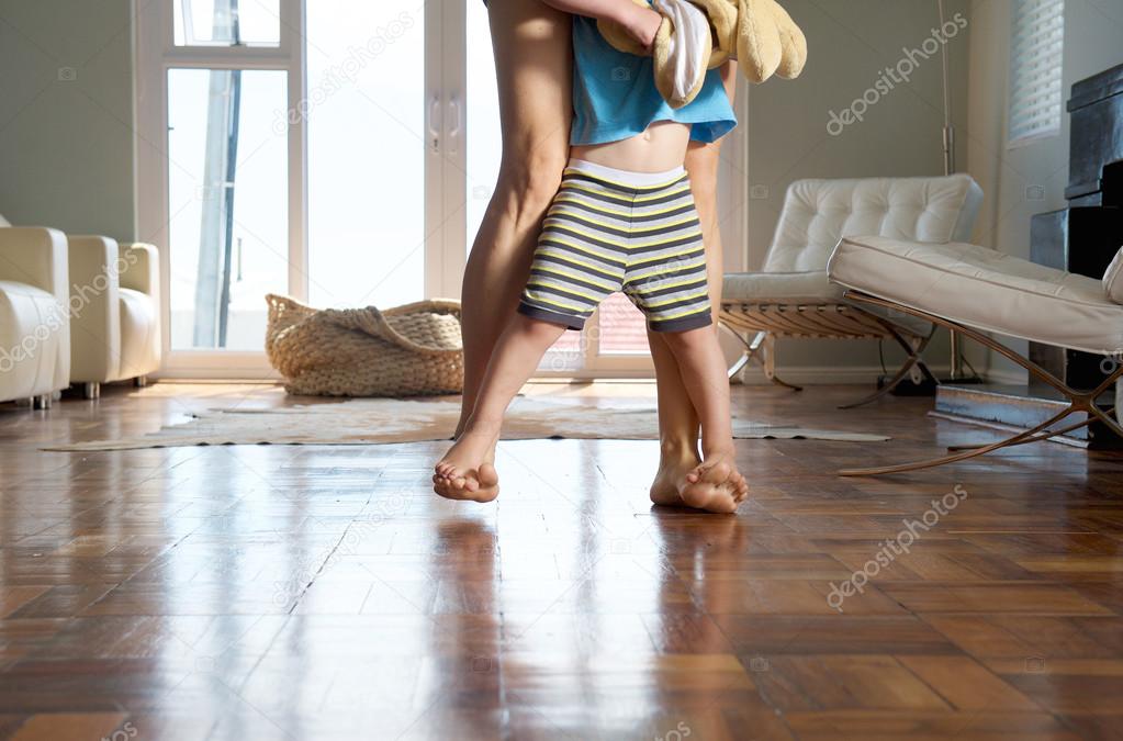 Mother and little boy walking at home