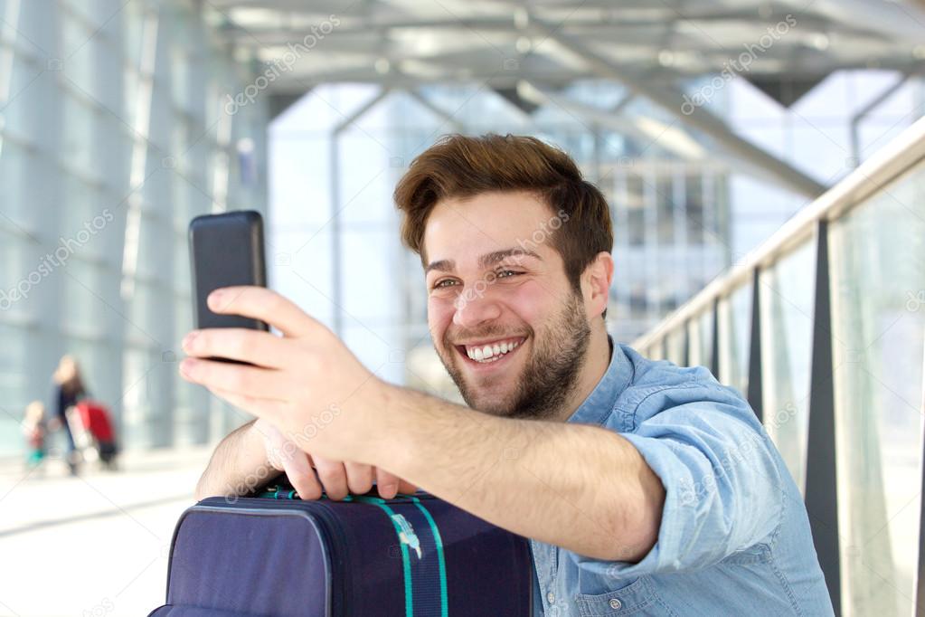 Young man laughing and taking selfie