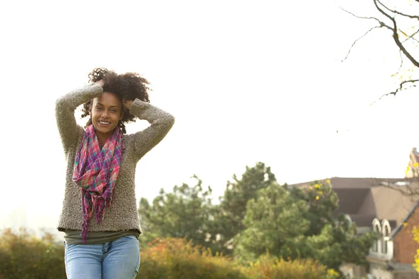 Sonriente joven afroamericana mujer con las manos en el pelo —  Fotos de Stock