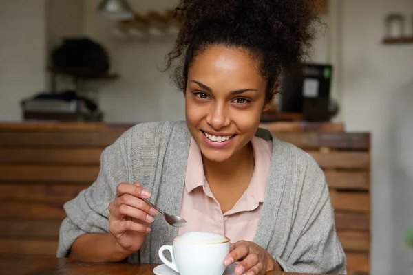 Happy young african american woman with cup of coffee — Stock Photo, Image