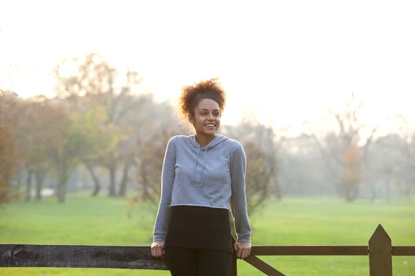 Happy young woman standing outdoors in nature — Stock Photo, Image