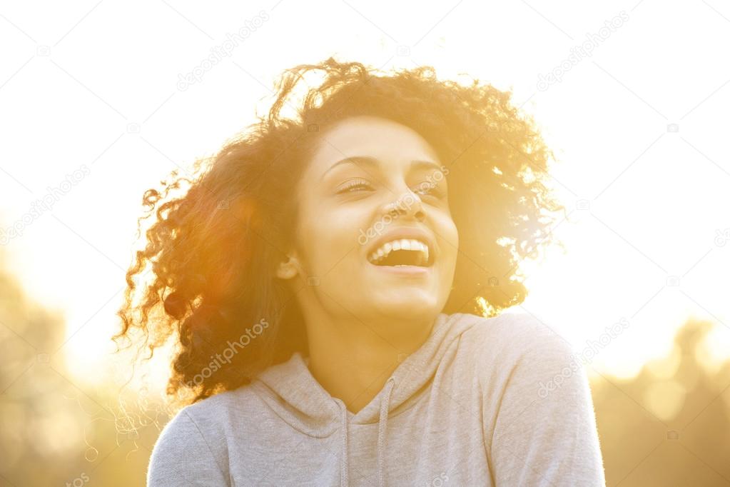 Happy african american girl laughing outdoors 