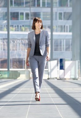 Attractive professional business woman walking 