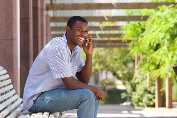 Sorrindo cara preto falando no celular fora — Fotografia de Stock