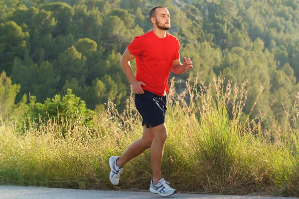 Fit man running outdoors — Stock Photo, Image