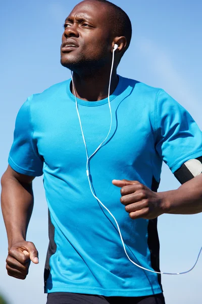 Healthy young man running outdoors — Stock Photo, Image