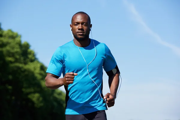 Fit young african american man running outdoors — Stock Photo, Image