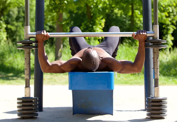 Bodybuilder Mann beim Heben von Gewichten — Stockfoto