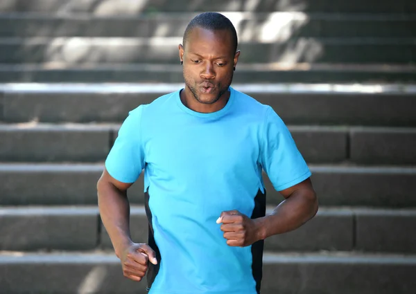 African american man running down stairs — Stock Photo, Image