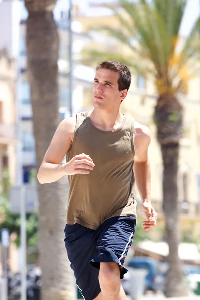 Young man running outdoors in summer — Stock Photo, Image