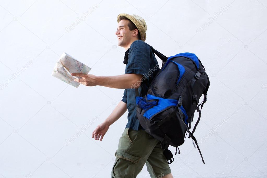 Smiling backpacker with map walking