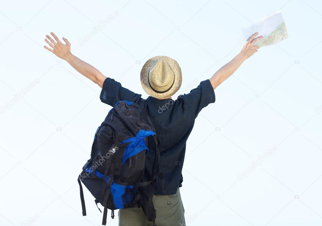 Backpacker standing with arms outstretched