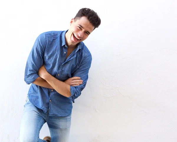 Cheerful young man in blue shirt laughing — Stock Photo, Image