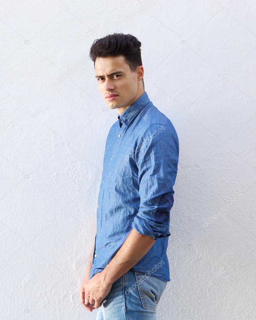 Handsome young man in denim blue shirt staring 