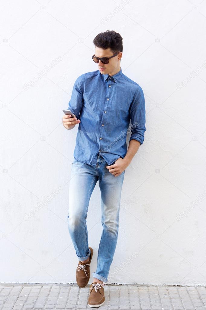 Cool hipster guy reading mobile phone message