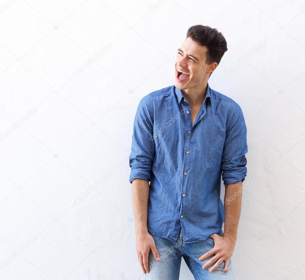 Cheerful young man laughing 