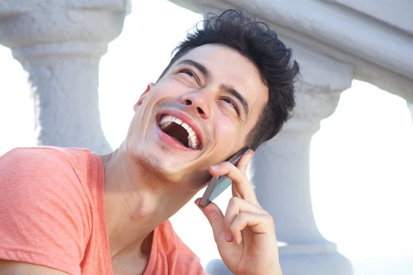 Jonge man lachen en luisteren op mobiele telefoon — Stockfoto