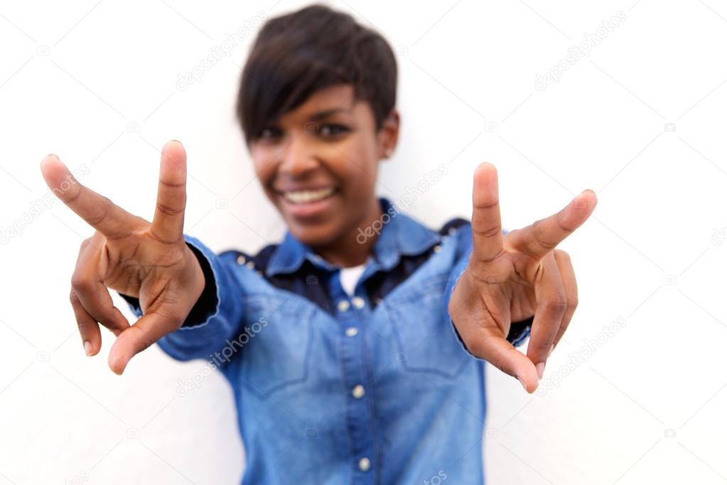 Smiling black woman with peace hand sign